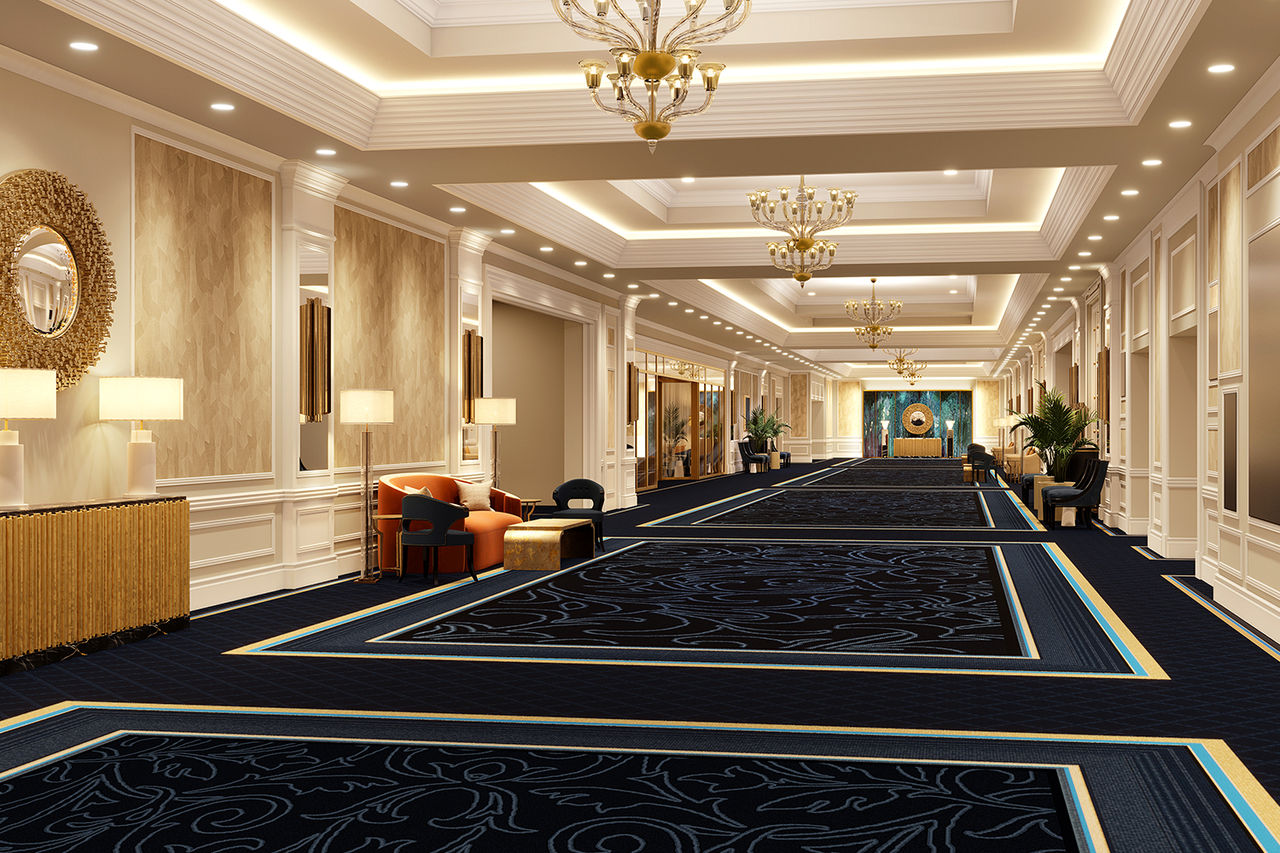 Meeting space with blue carpet, gold chandeliers, vaulted ceiling, done up in an Italian style decor.