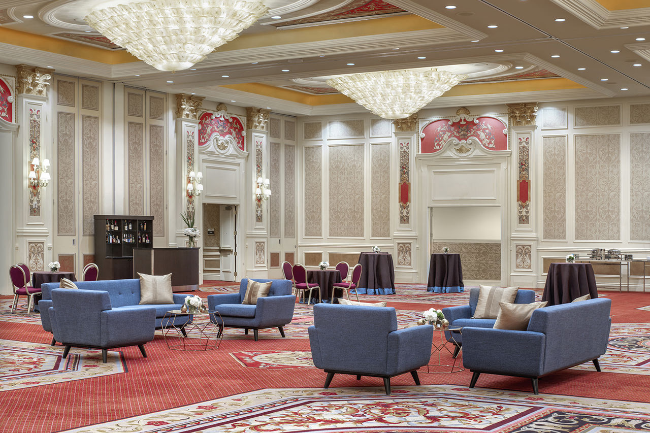Interior of a ballroom at the Venetian Resort. This room has couches, chairs, and tables set up for an event. 